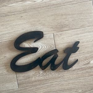 Metal hanging “Eat” sign